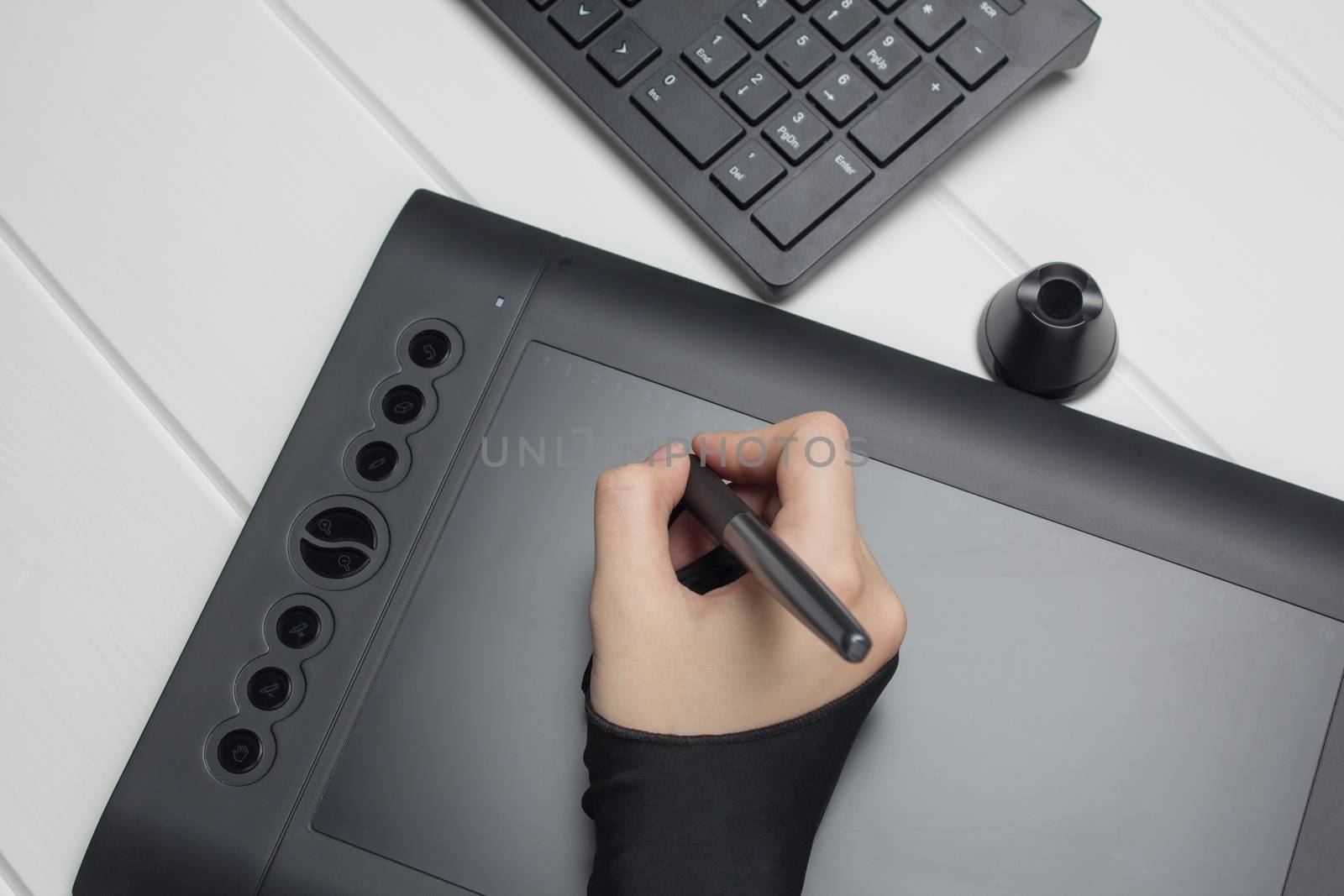 Graphic designer working on digital tablet. The hand draws on a  by NataliSam