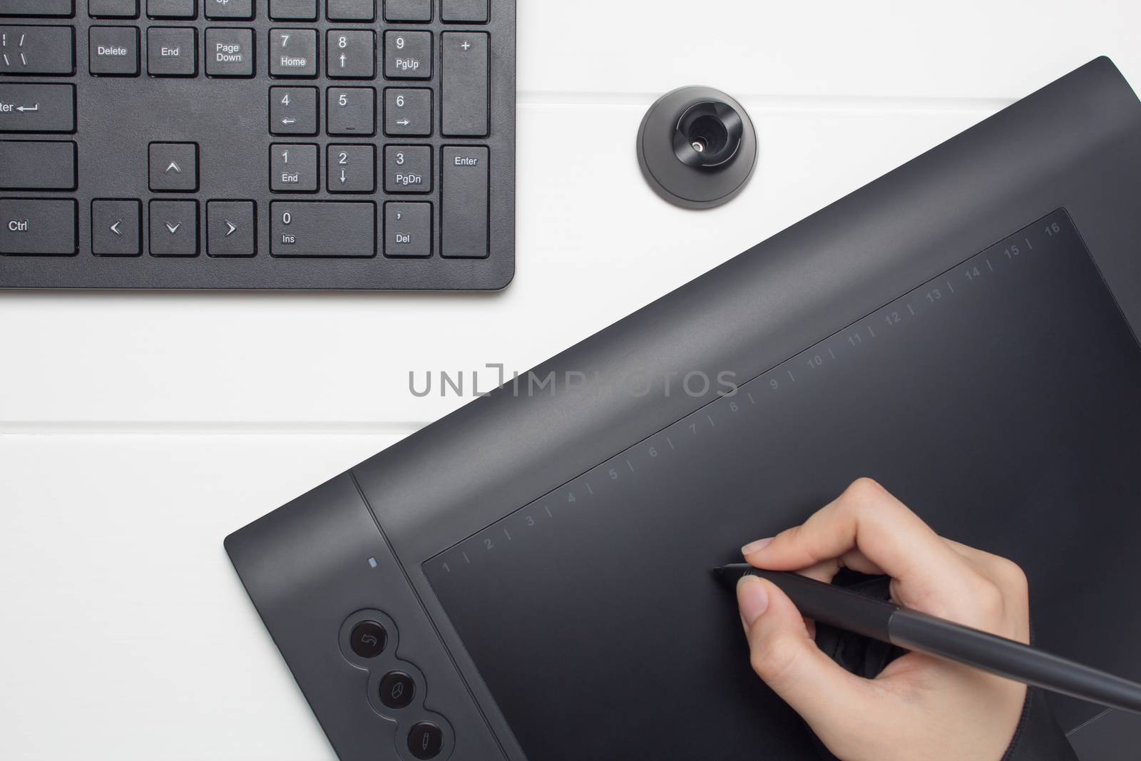 Graphic designer working on digital tablet. The hand draws on a graphics tablet. Freelance, designer, Illustrator. Technology, remote work, outsourcing.Project, concept, close-up, creativity. Glove