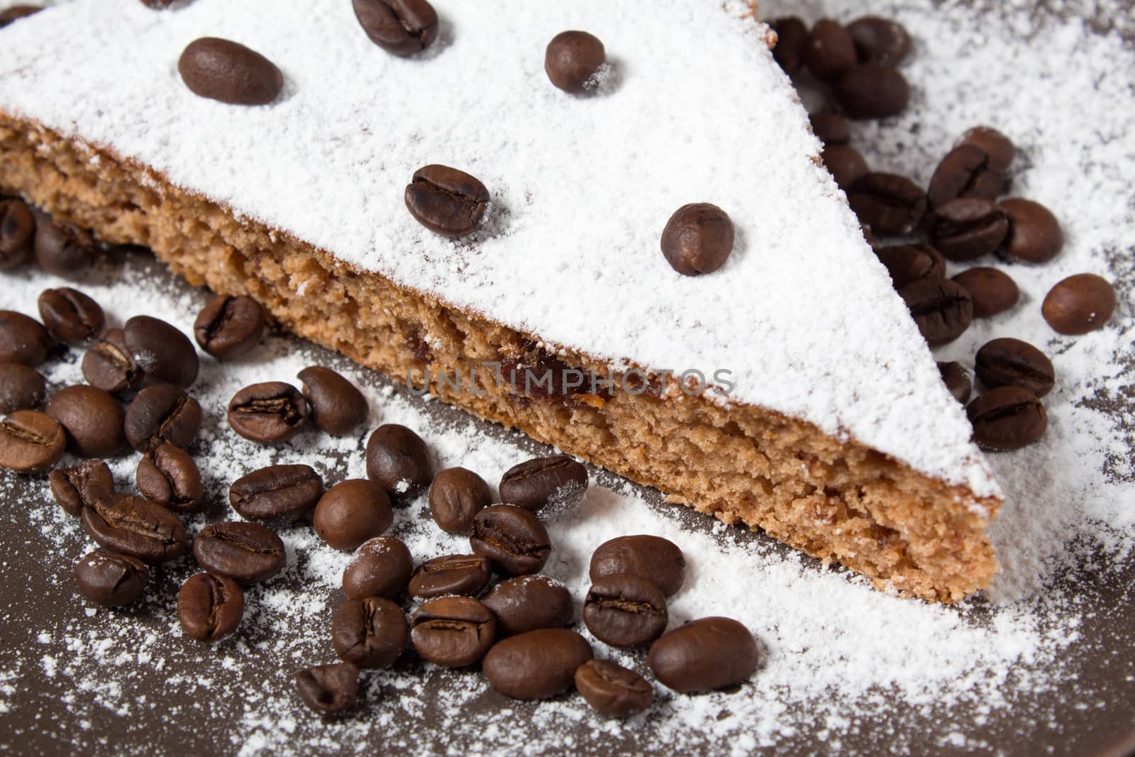 A piece of chocolate cake with sugar and coffee beans. Food, dessert, sweet. Biscuit, brownie, tiramisu, cheesecake. Cook at home. Bakery products.