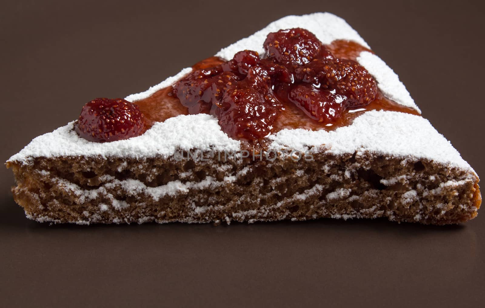 A piece of cake with strawberry jam and sugar. Dessert, food, sweet, baking. Biscuit, brownie, tiramisu, cheesecake. Cook at home, homemade, closeup, Bakery products.
