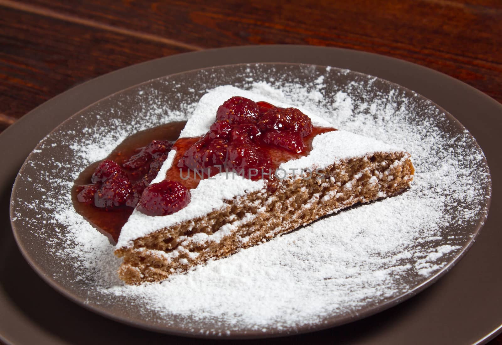 A piece of cake with strawberry jam and sugar. Dessert, food, sweet, baking. Biscuit, brownie, tiramisu, cheesecake. Cook at home, homemade, closeup, Bakery products.