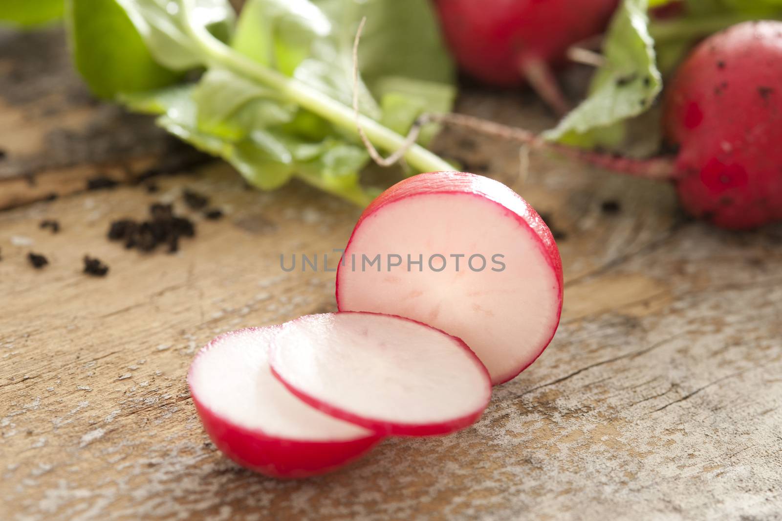 Close-up of sliced fresh harvested radish on table by stockarch