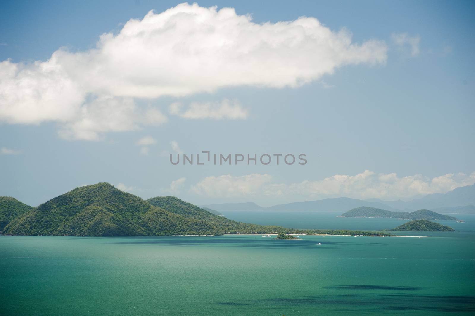 View of beautiful nature of Dunk Island in sunny day with bright white cloud over sea and forest covered hills - Queensland, Australia