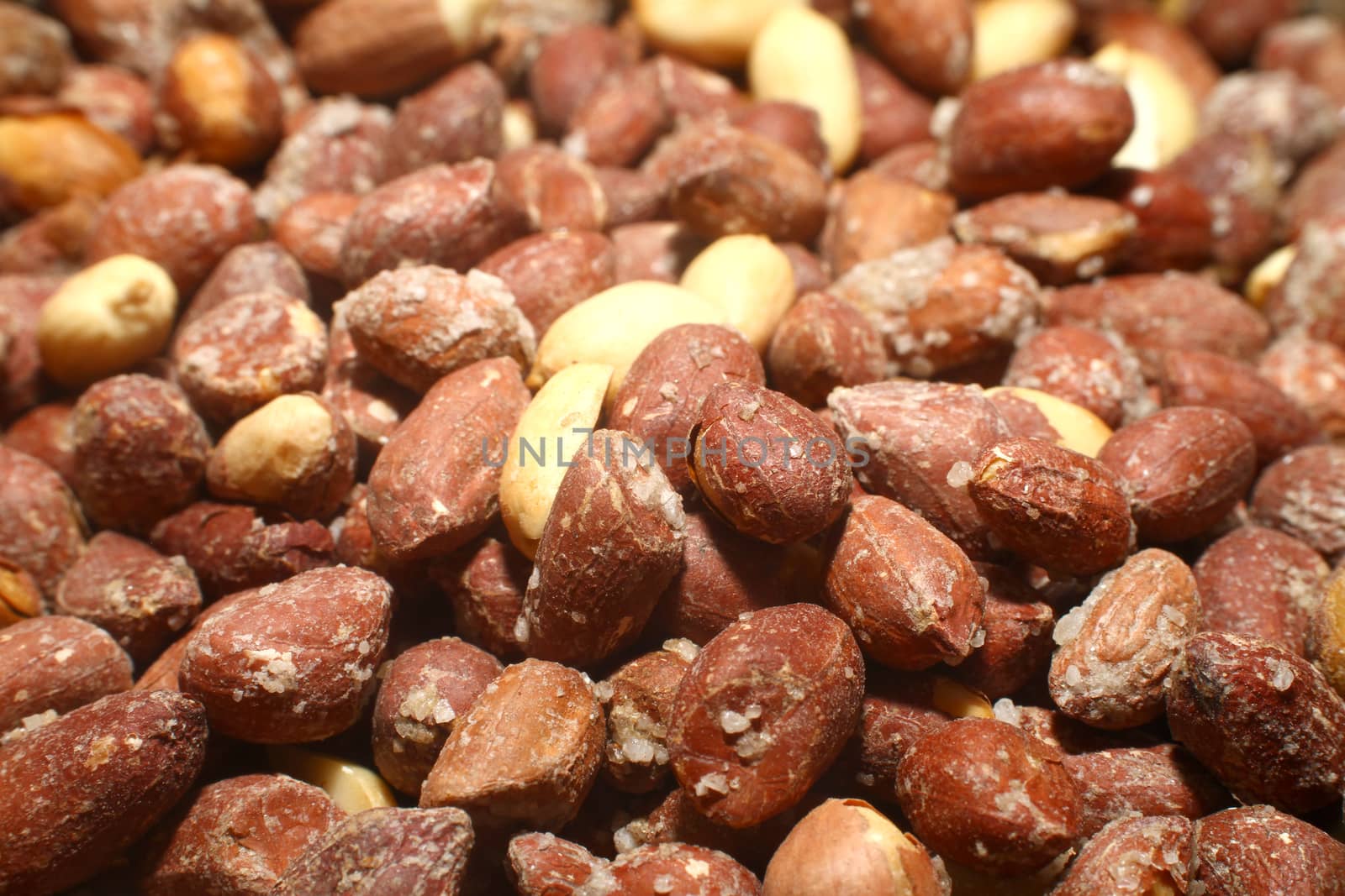salted roasted peanuts in market, macro close up