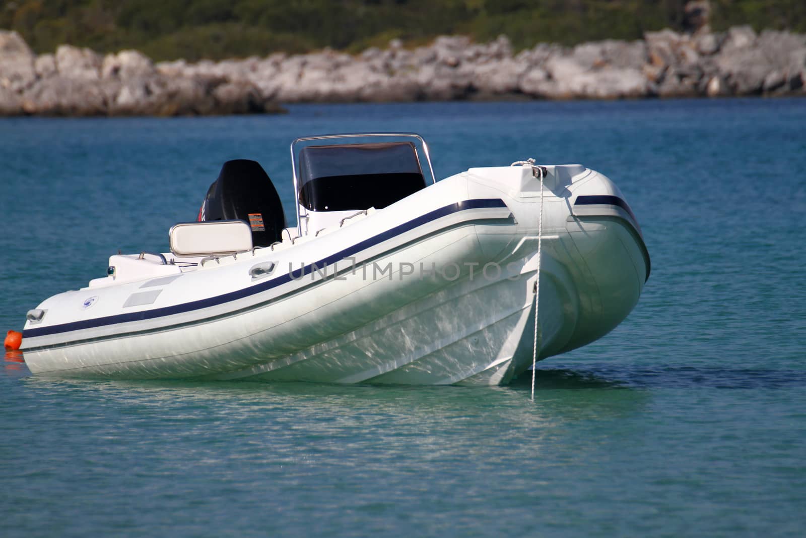 luxury speedboat parked at blue sea at day