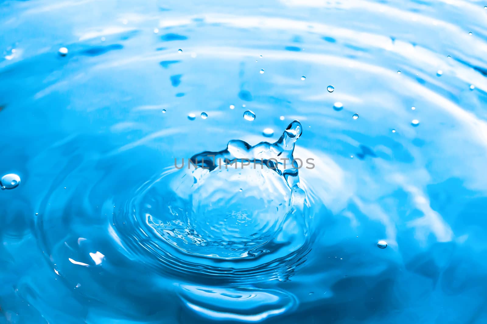 Water splash close-up. Drop of water. Blue water drop. Falling b by YevgeniySam