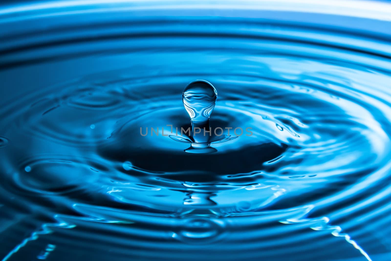 Water splash close-up. Drop of water. Blue water drop. Falling b by YevgeniySam