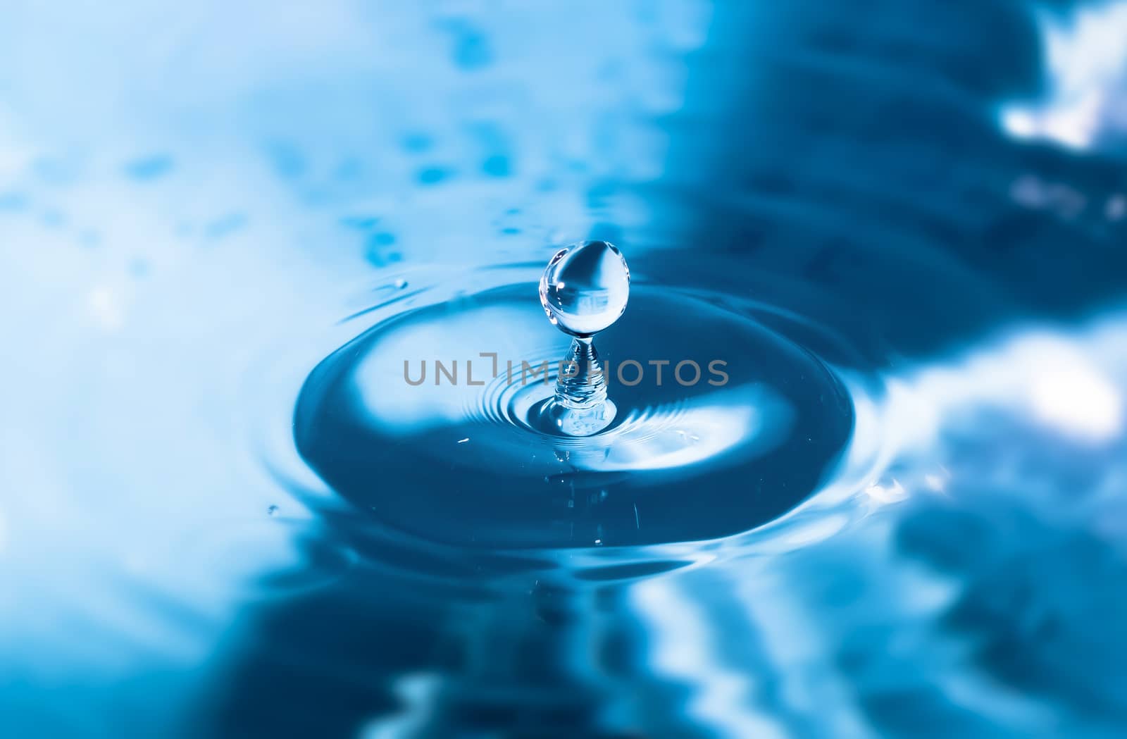 Water splash close-up. Drop of water. Blue water drop. Falling b by YevgeniySam