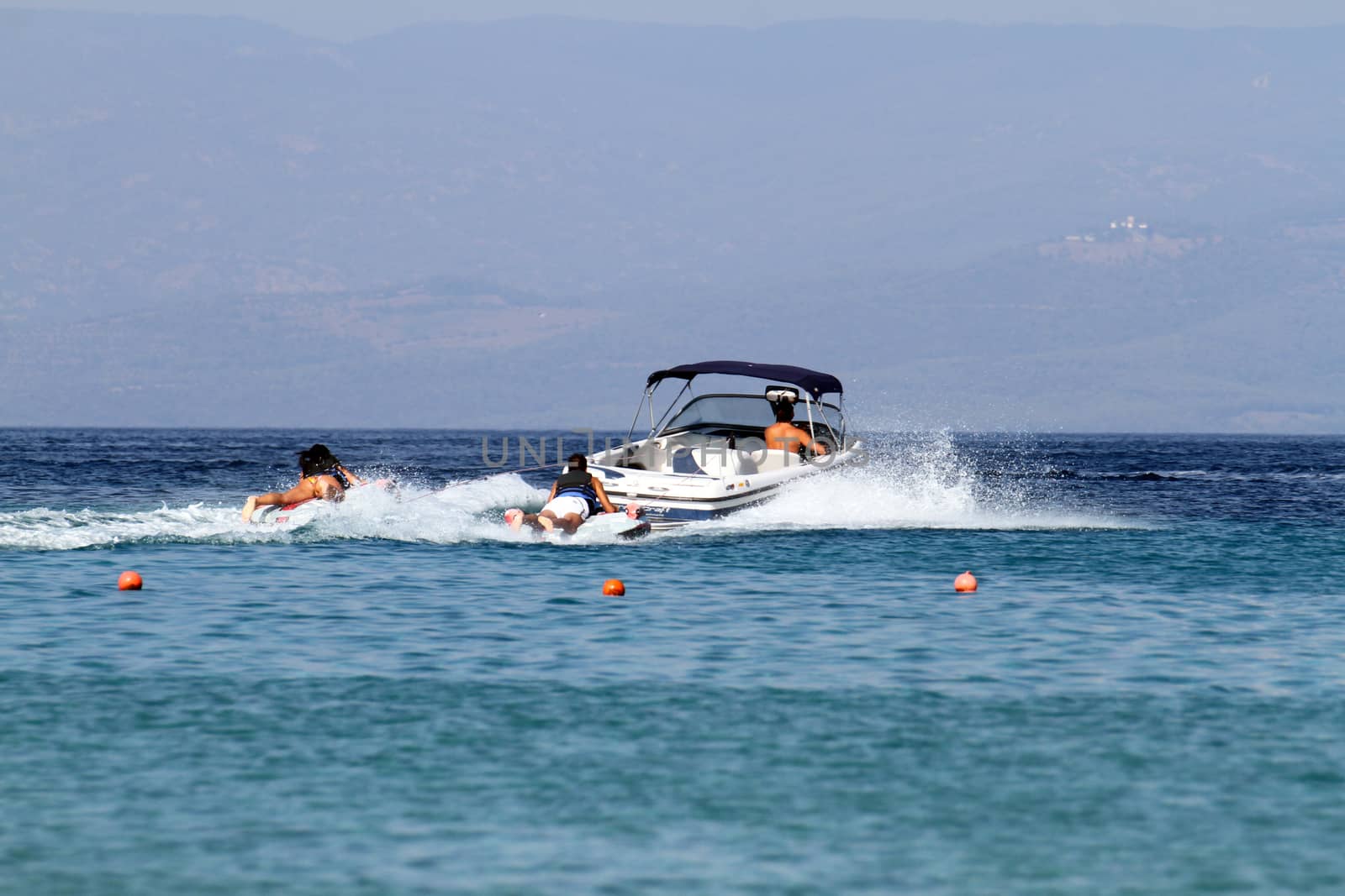 speedboat pulls people skating in the water by alex_nako