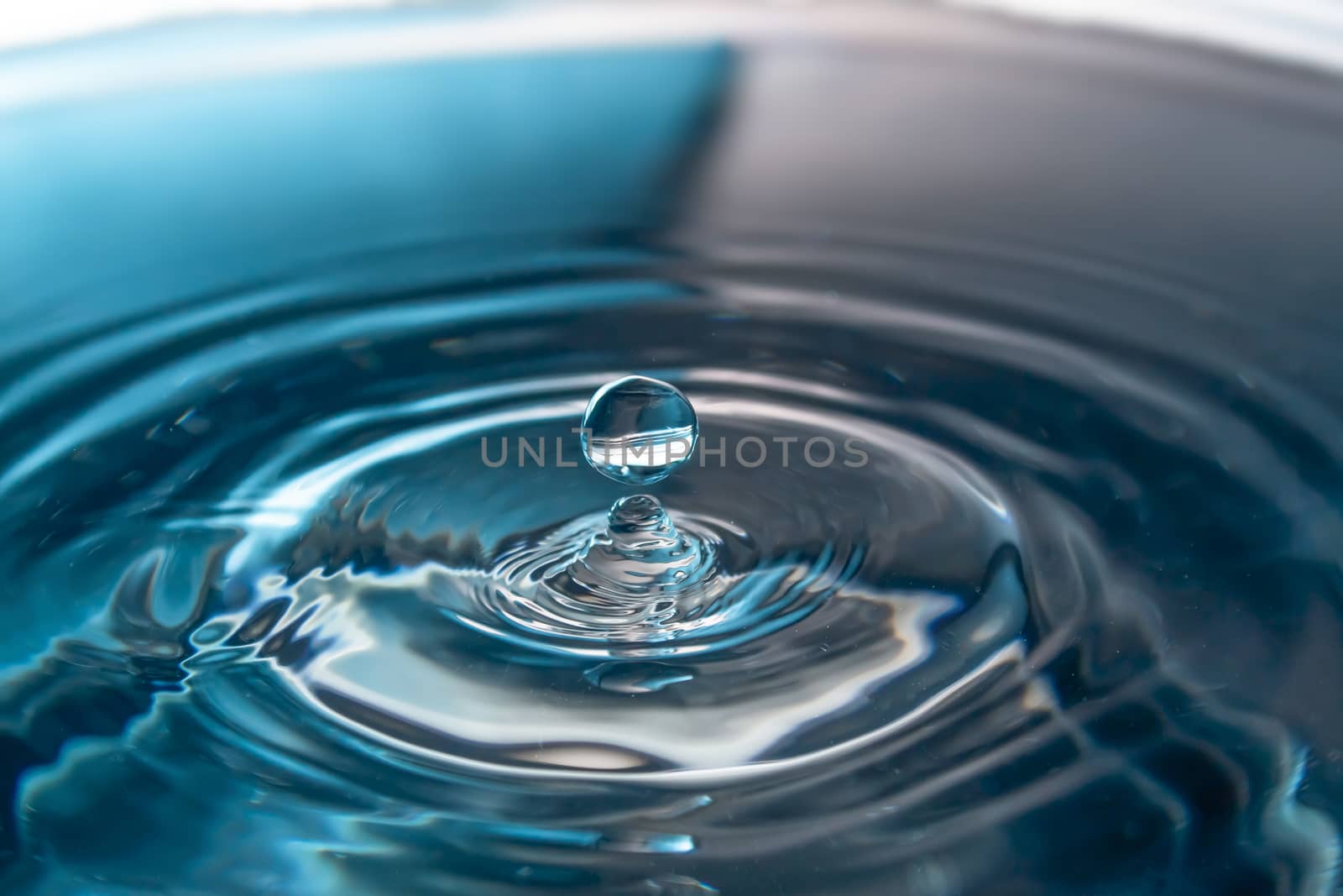 Water splash close-up. Drop of water. Blue water drop. Falling b by YevgeniySam