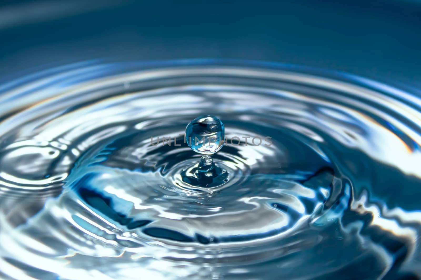 Water splash close-up. Drop of water. Blue water drop. Falling b by YevgeniySam