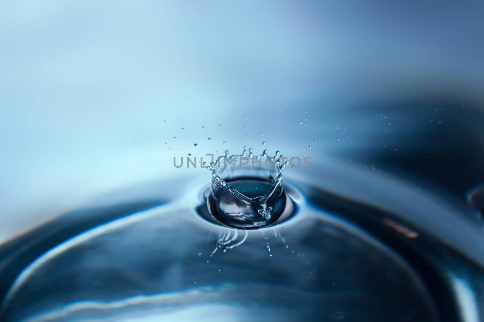 Water splash or drop. Water splash close-up. Blue water drop. Falling water