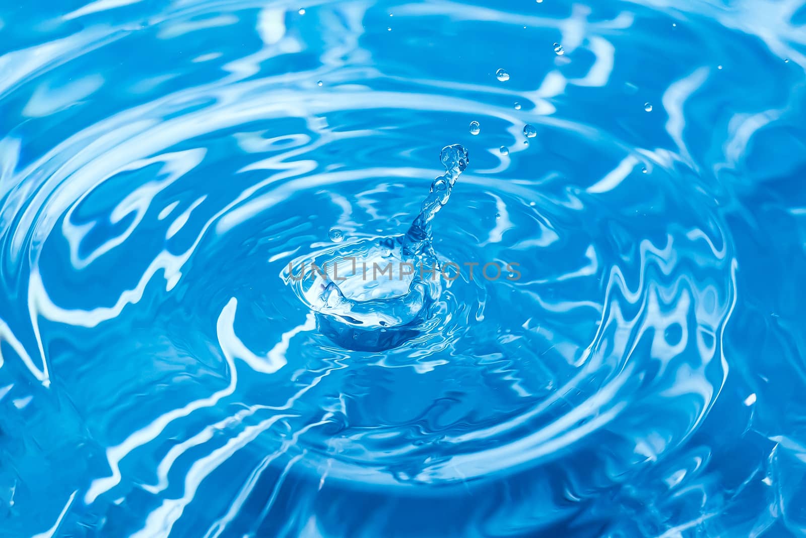 Water splash or drop. Water splash close-up. Blue water drop. Falling water