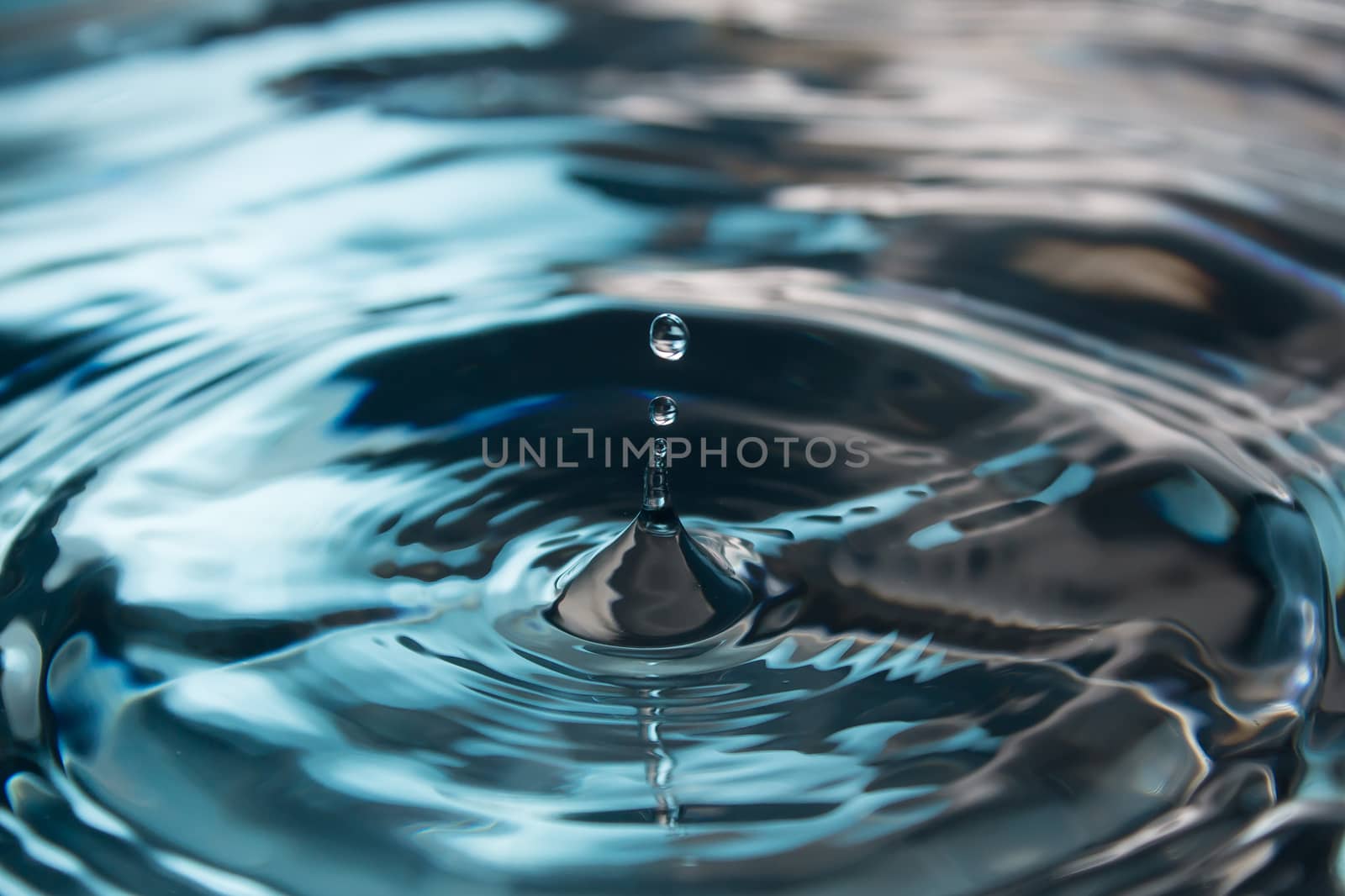 Water splash or drop. Water splash close-up. Blue water drop. Falling water