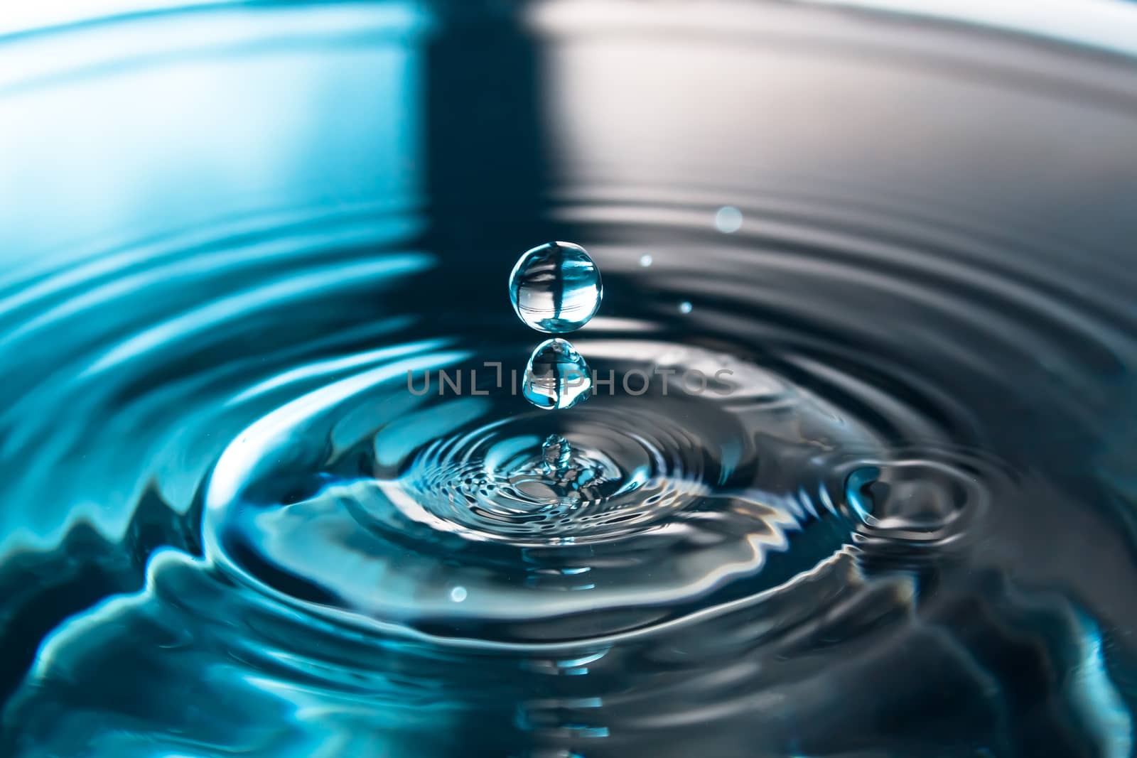 Water splash or drop. Water splash close-up. Blue water drop. Falling water