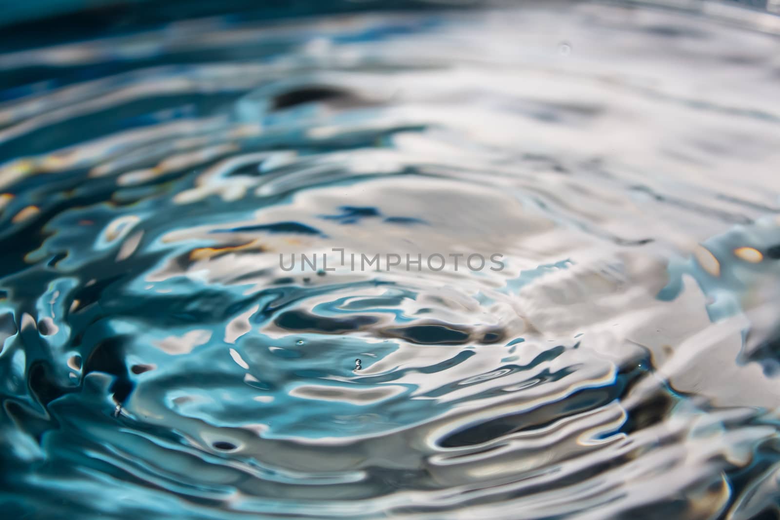 Water splash or drop. Water splash close-up. Blue water drop. Falling water