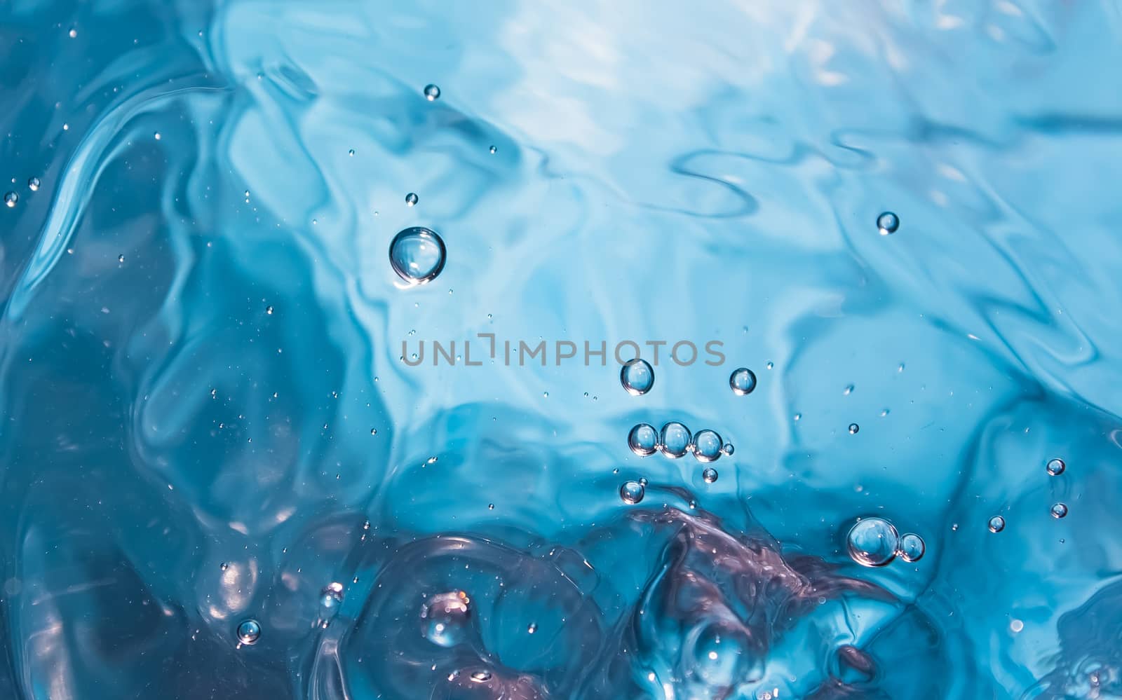 Water splash close-up. Crown of blue water. Water drop