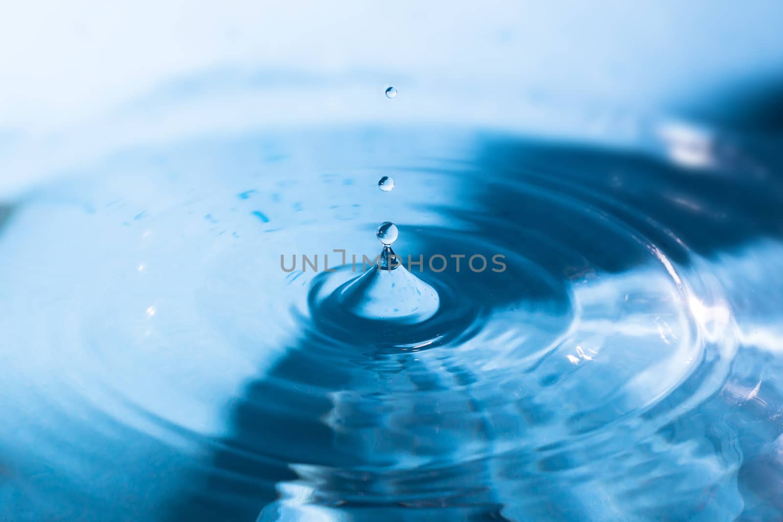 Water splash close-up. Crown of blue water. Water drop. Aqua background