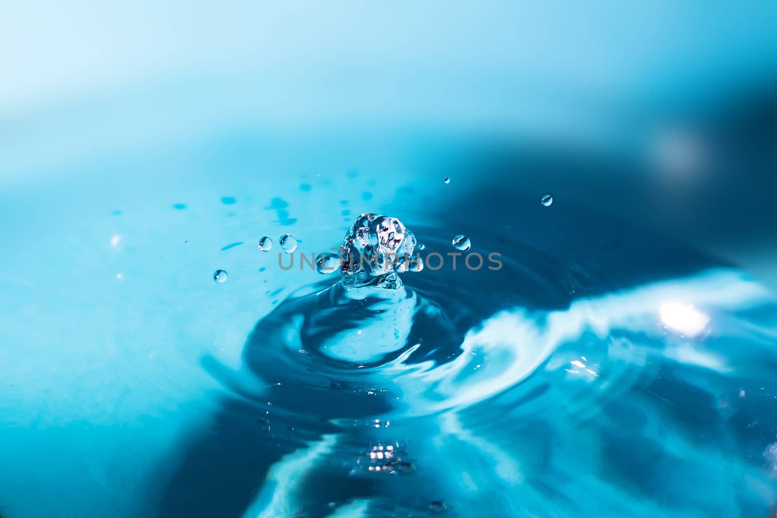 Water splash close-up. Crown of blue water. Water drop. Aqua background