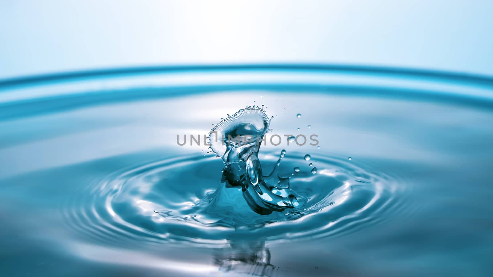 Water splash close-up. Drop of water. Blue water drop. Falling b by YevgeniySam