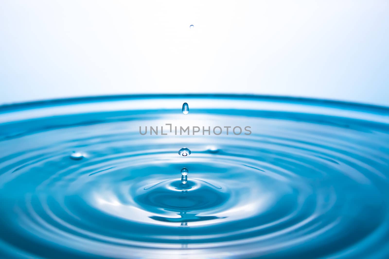 Water splash close-up. Drop of water. Blue water drop. Falling b by YevgeniySam