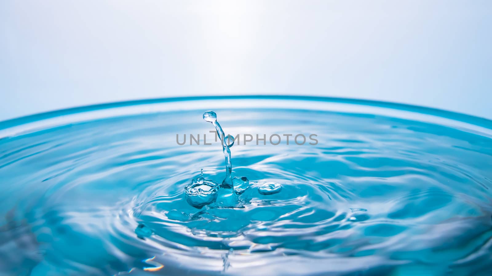 Water splash close-up. Drop of water. Blue water drop. Falling b by YevgeniySam