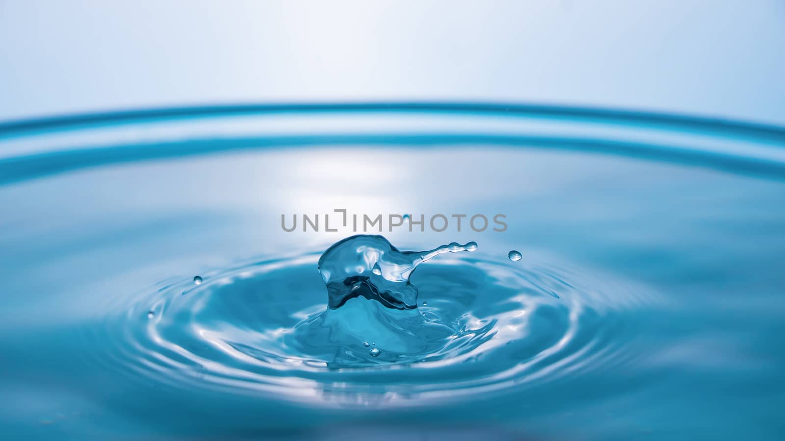 Water splash close-up. Drop of water. Blue water drop. Falling b by YevgeniySam