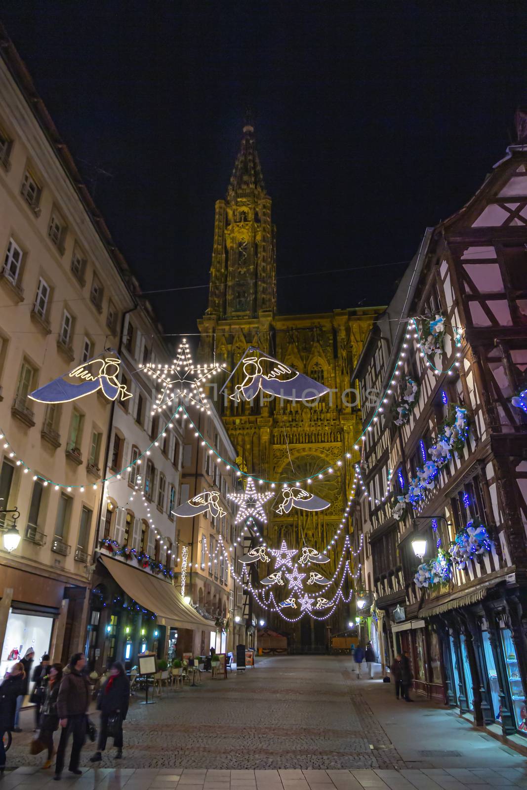 Late night shopping time in front Strasbourg cathedral during the festive and happening Christmas season