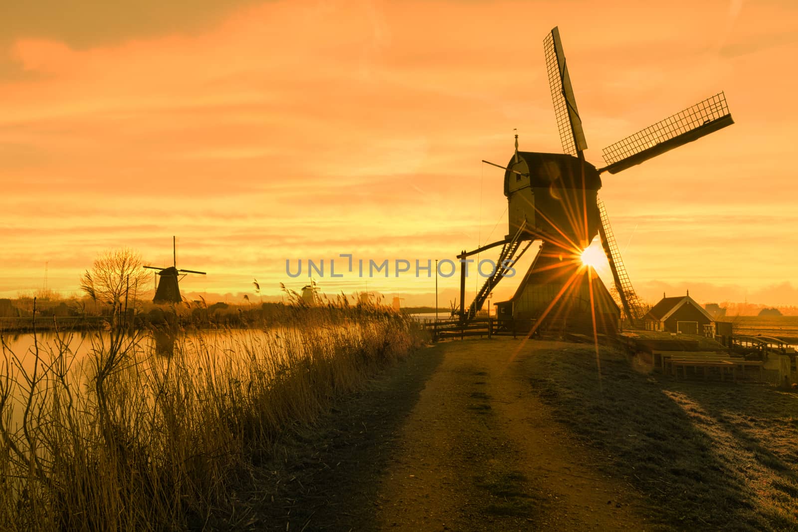 Twight light sunrise on the Unesco heritage windmill silhouette at the middle of the canal, Alblasserdam, Netherlands