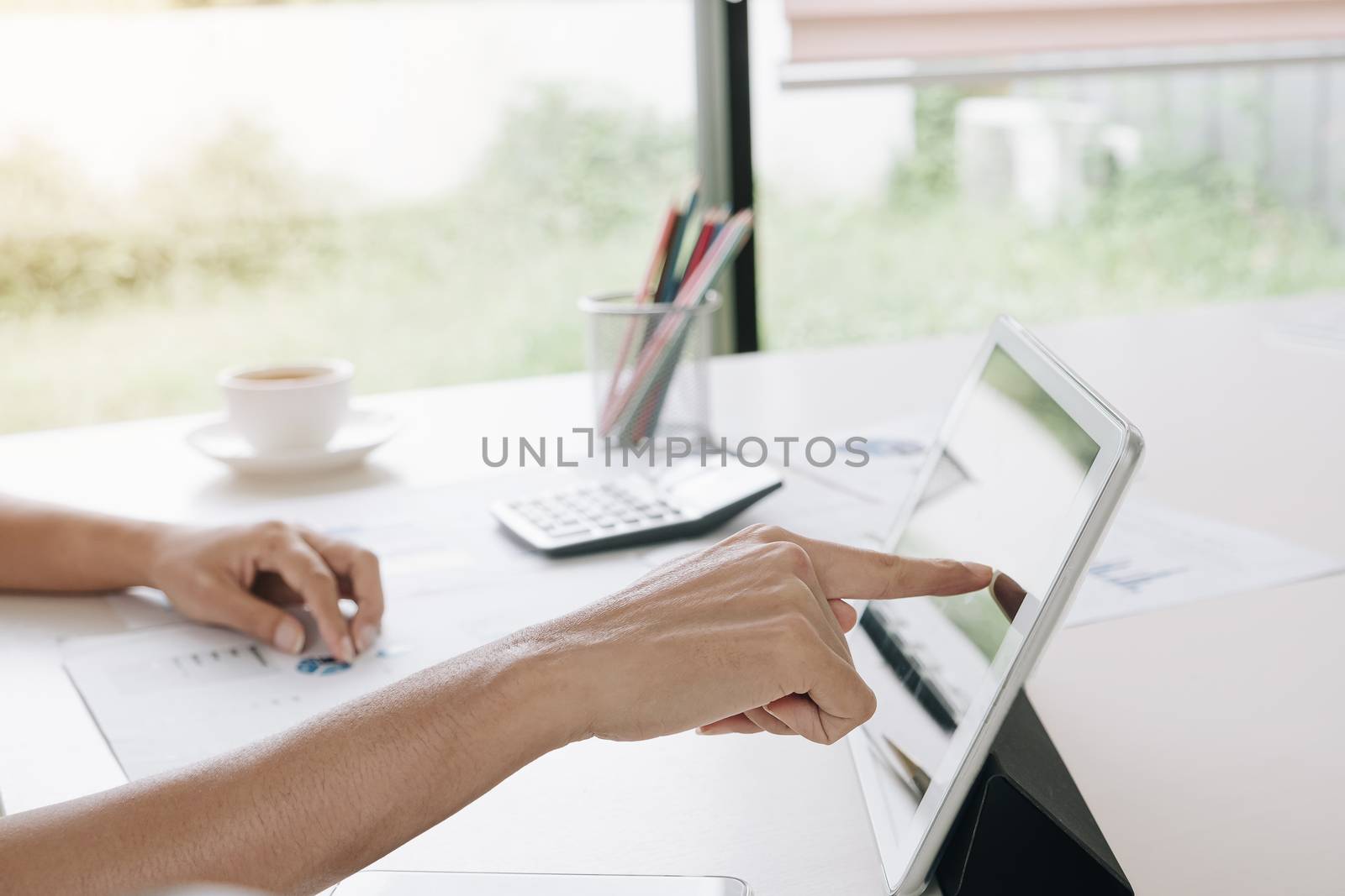 Business woman hand  pointing at screen of laptop computer, anal by wichayada