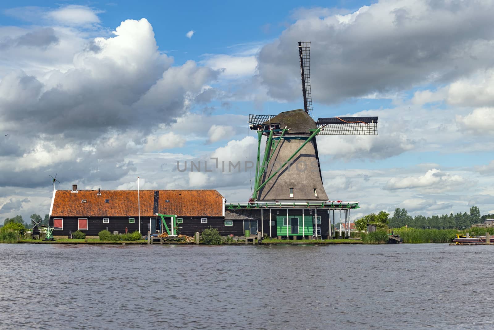 Dutch sawmill at the border of the lake waiting for tree trunks delivery, Zaanse Schans, Netherlands