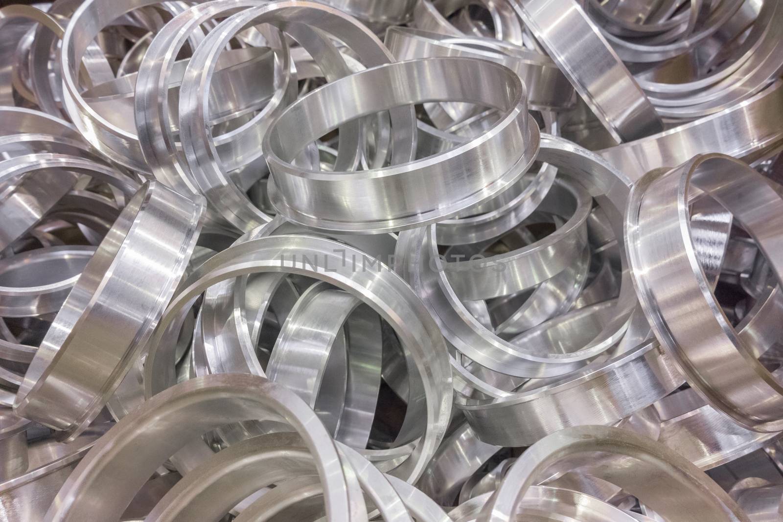 Shiny aluminium cnc turned rings background with selective focus