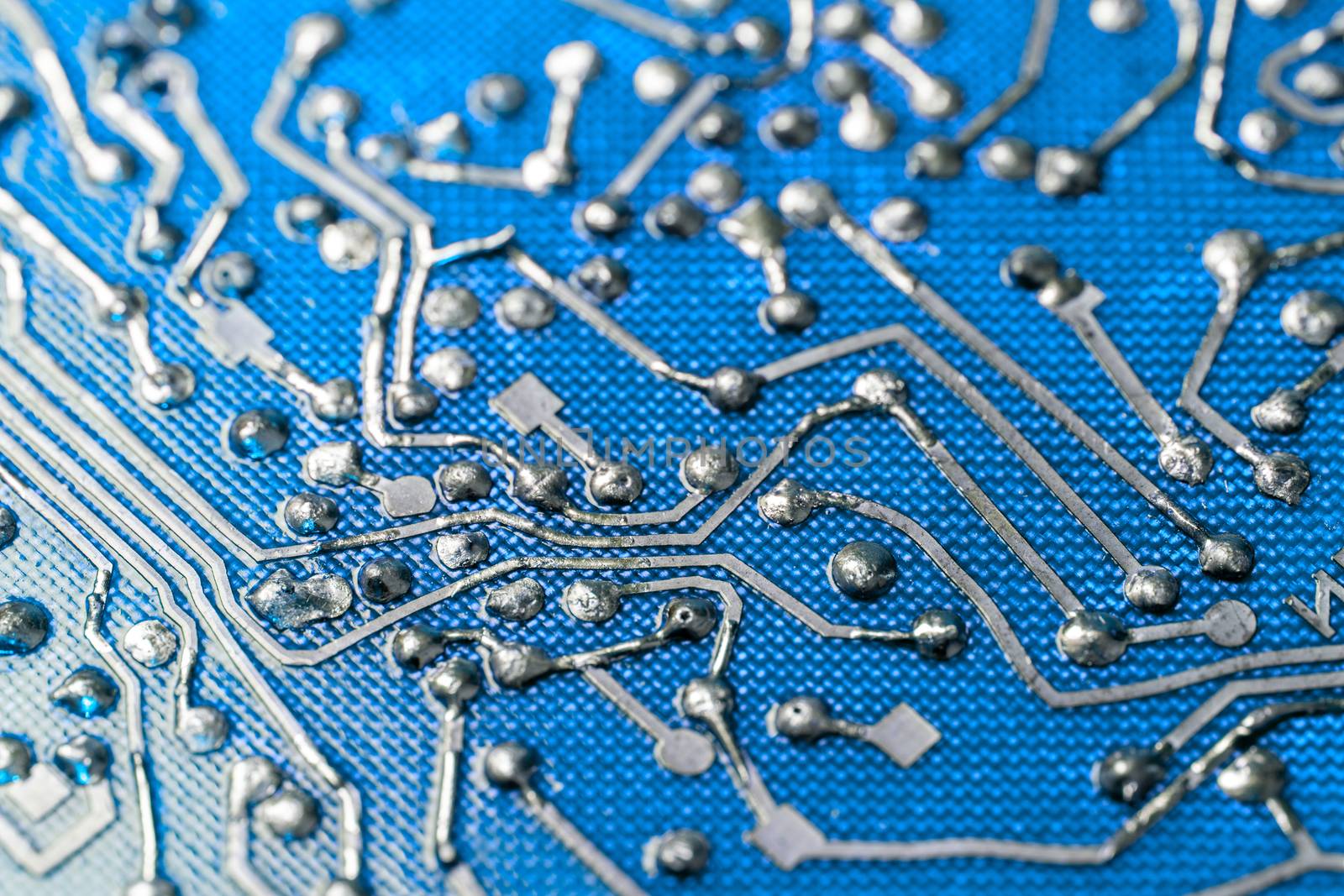 back side of old flat bare fiberglass pcb without components with selective focus