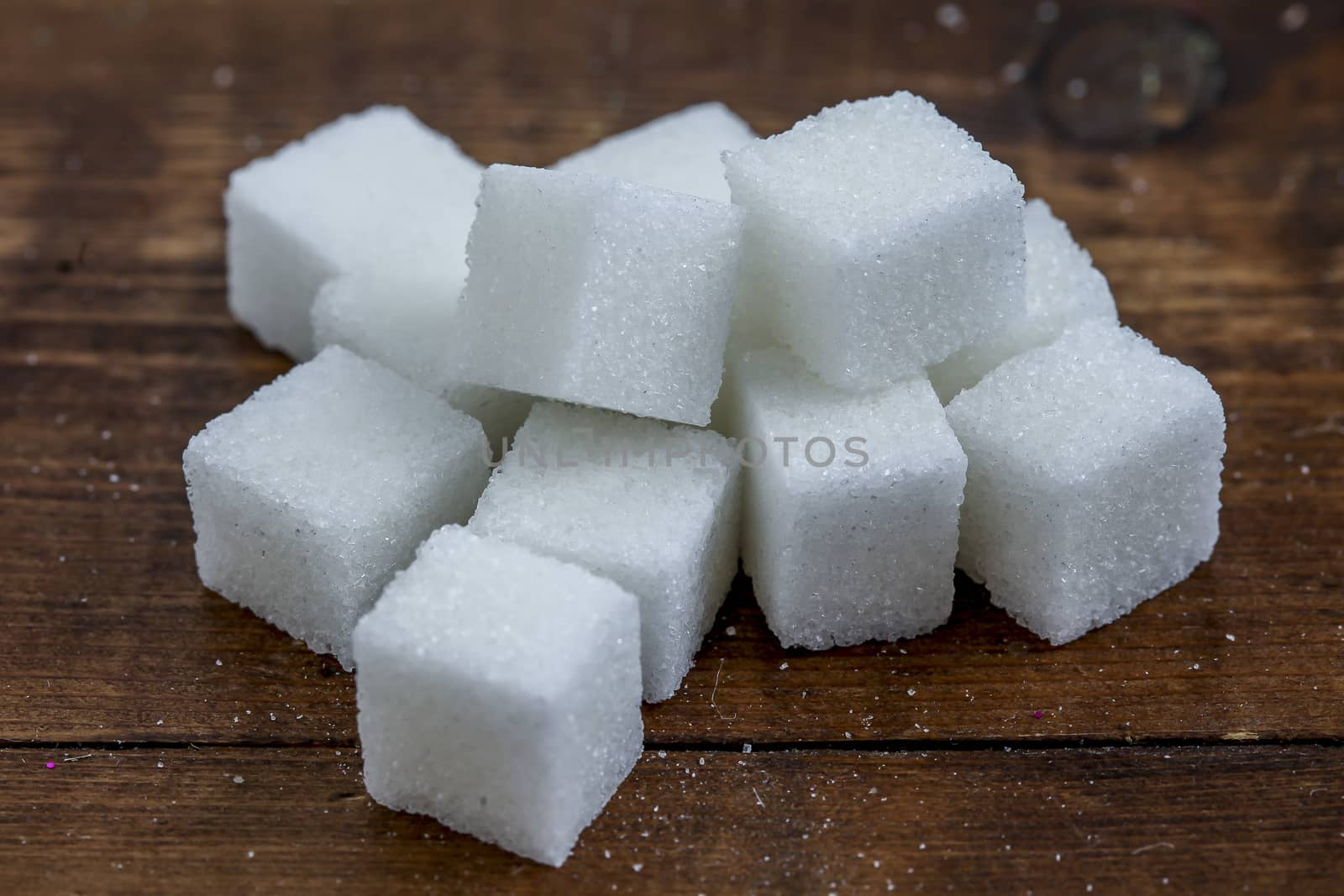 Sugar cubes on wooden background