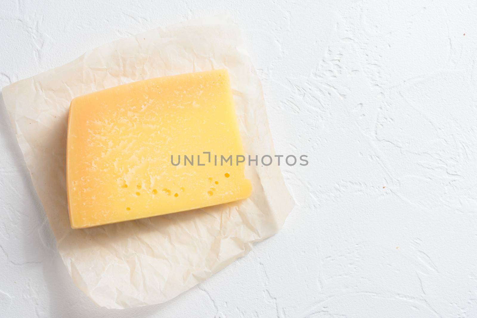 Parmesan cheese on white stone surface top view space for text by Ilianesolenyi