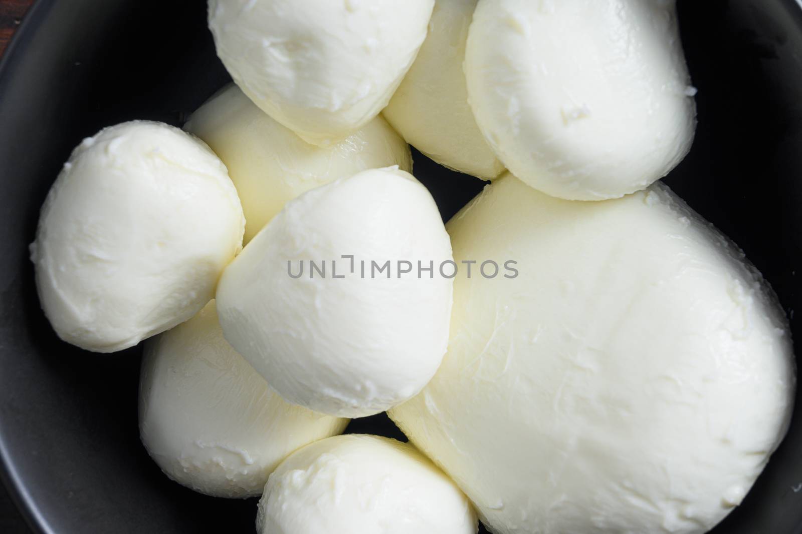 Raw ripe Mozzarella buffalo cheese balls on old wood background top view close up selective focus