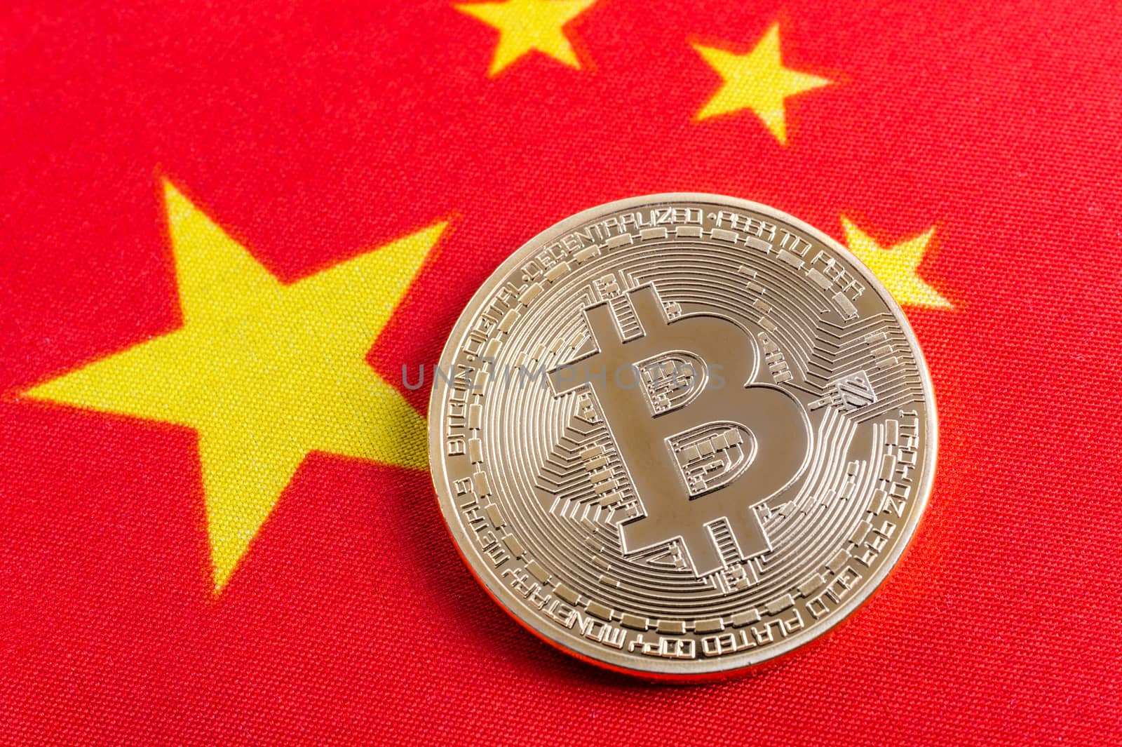 Bitcoin real coin over chinese flag fabric by mbruxelle