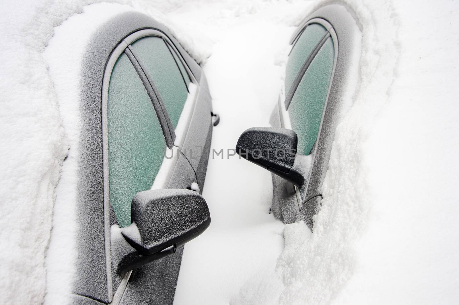 Car mirrors of two cars buried in the snow after snowstorm (Mont by mbruxelle