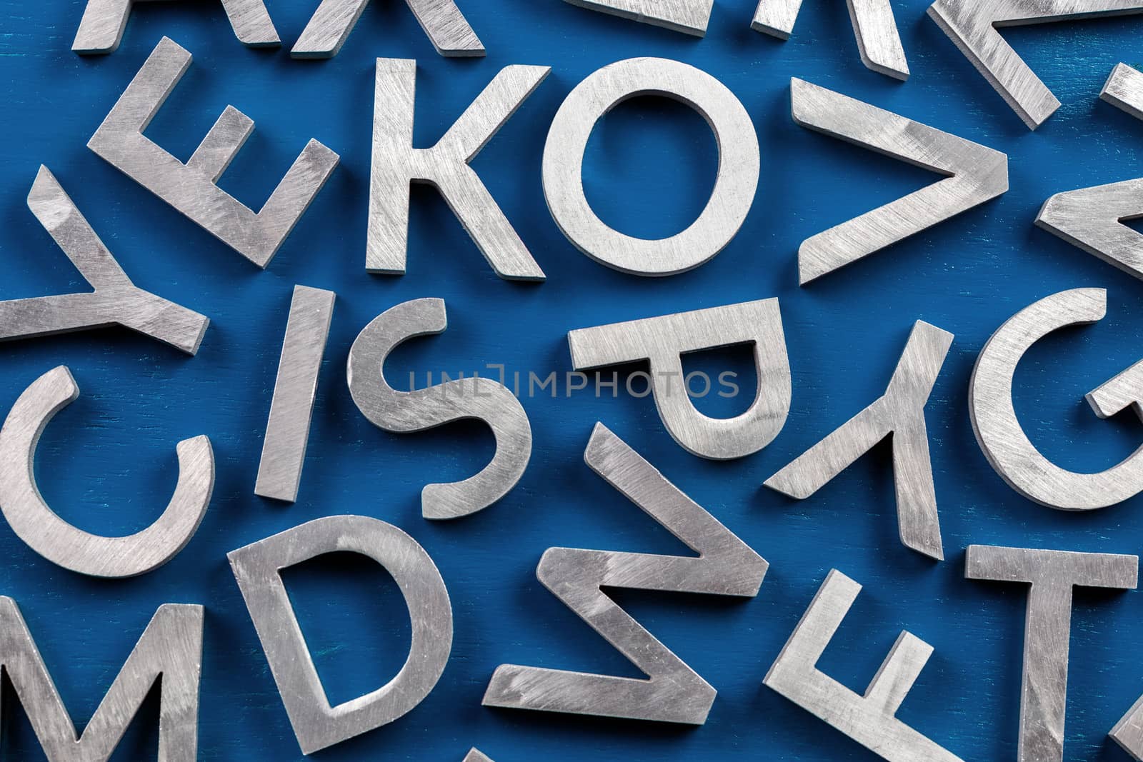 Abstract flat background of silver metal english alphabet characters on classic blue background. by z1b