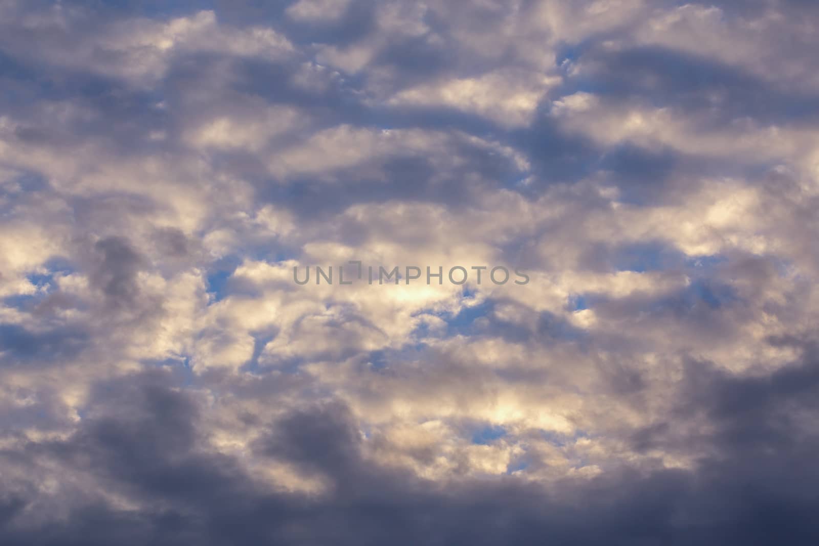 Stratocumulus evening clouds pastel view telephoto background