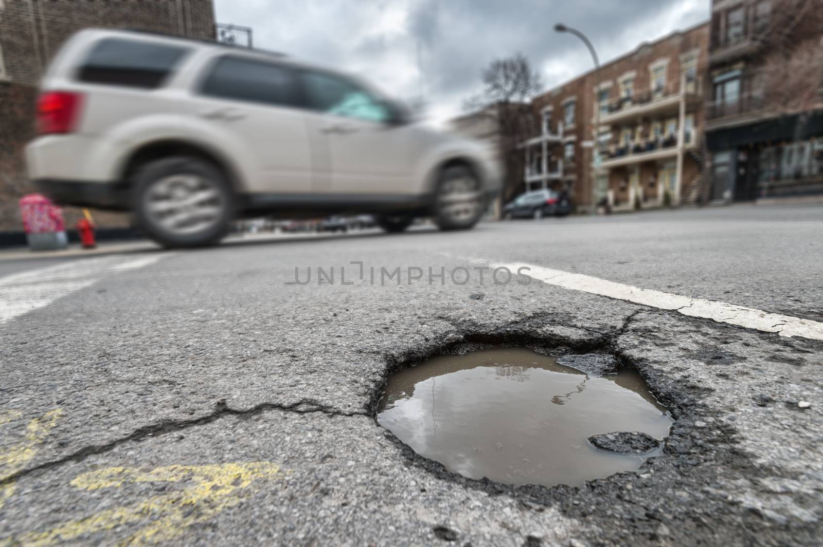 Large unrepaired pothole on Laurier street in Montreal, Canada ( by mbruxelle