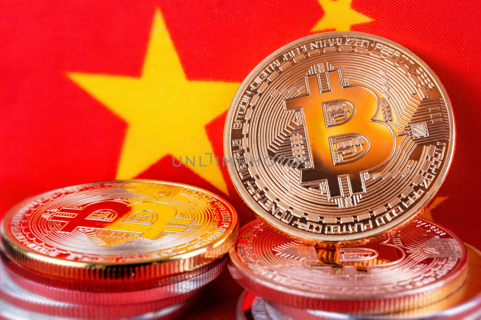 Bitcoin real coins over chinese flag fabric by mbruxelle