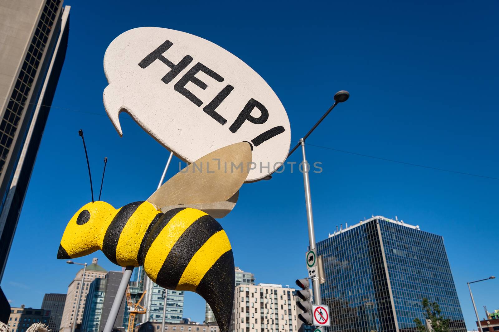 Fake bee with Help Sign during climate march in Montreal.