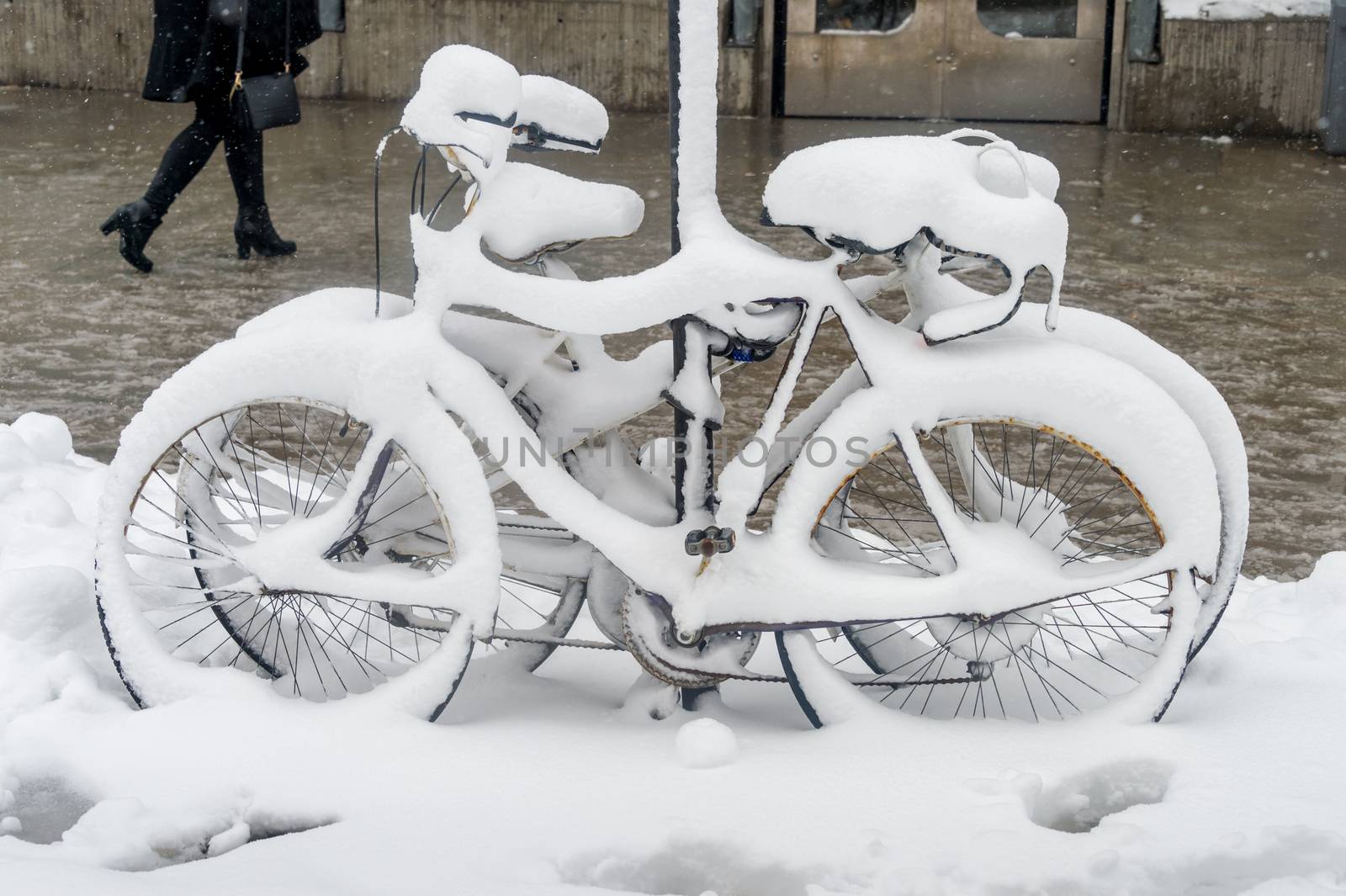 Bike covered with fresh snow in Montreal, Canada, 2018. by mbruxelle