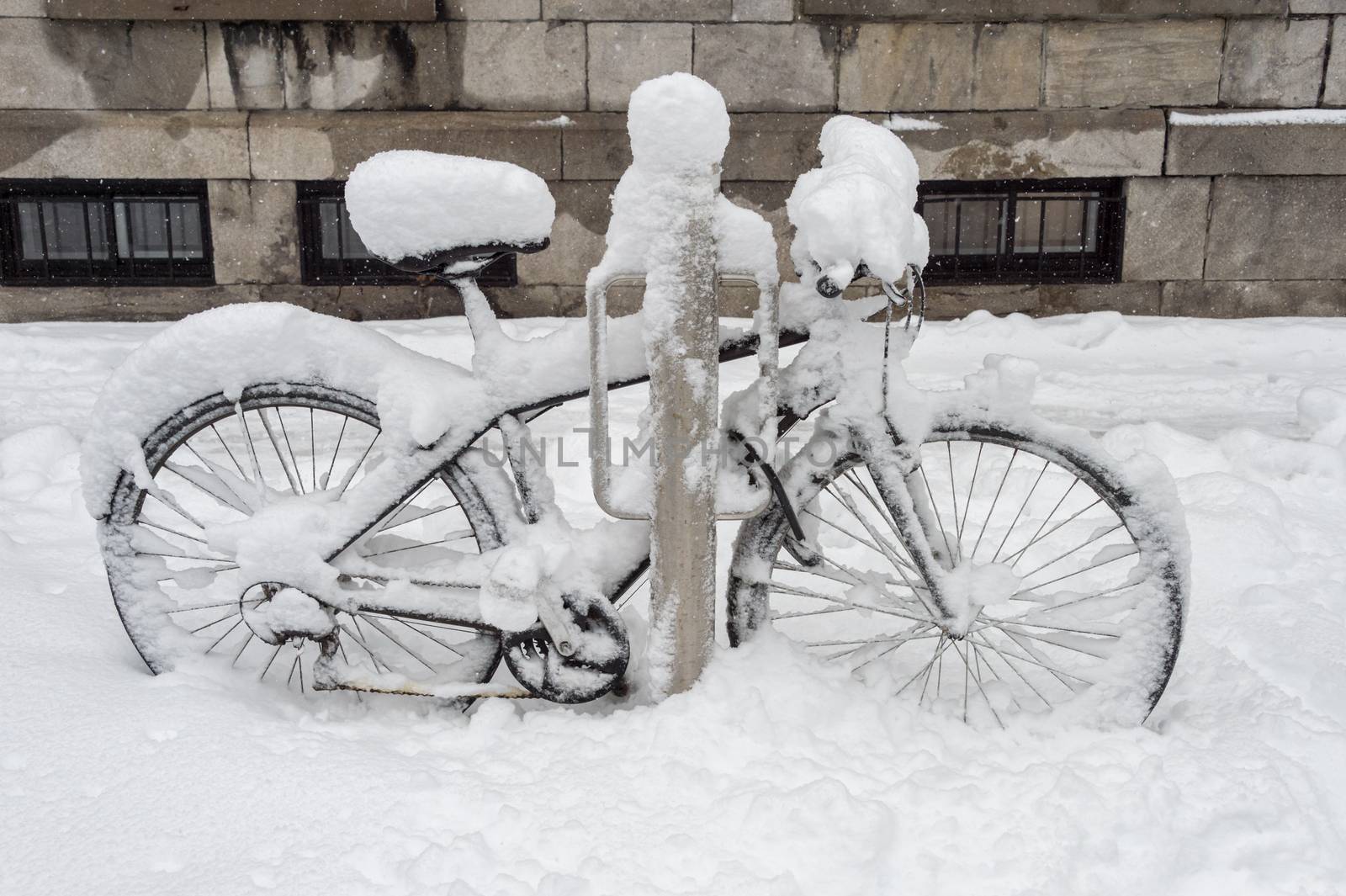 Bike covered with fresh snow in Montreal, Canada, 2018. by mbruxelle