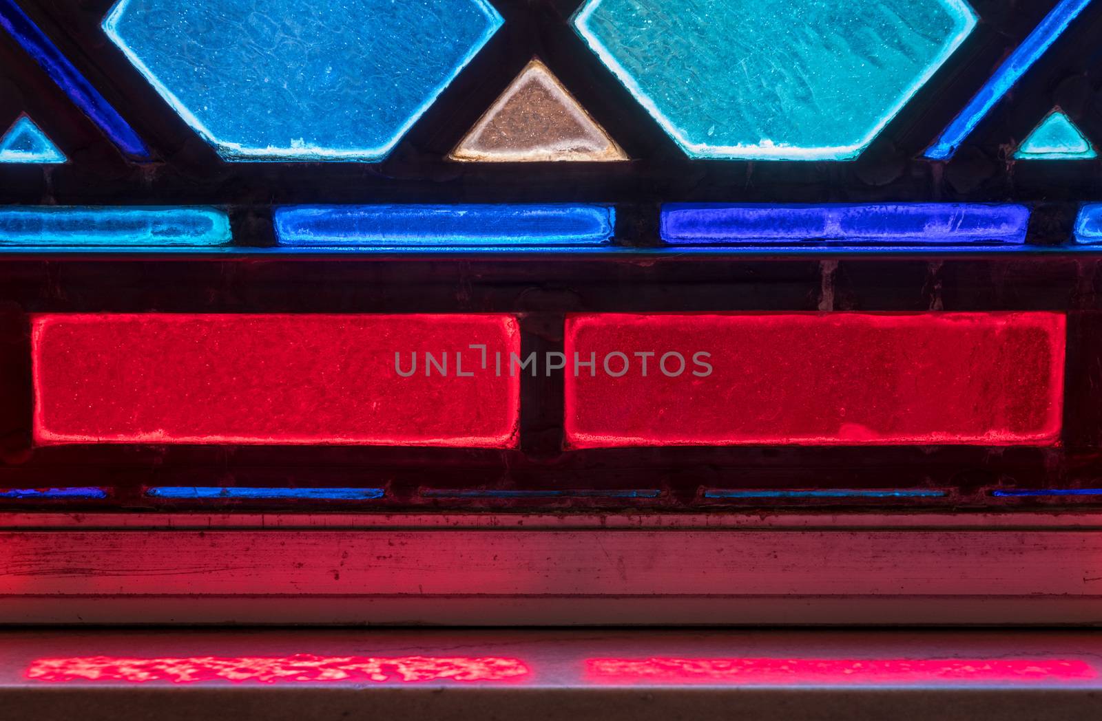 Detail of colored light from stained glass window in catholic church