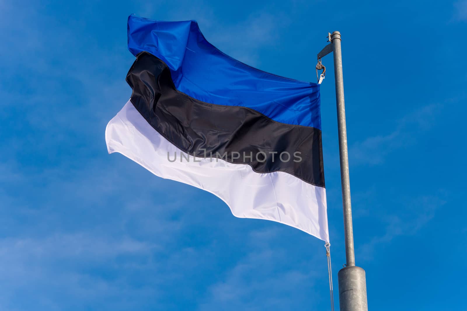Estonian flag waving against blue sky in Boulogne sur Mer, Franc by mbruxelle