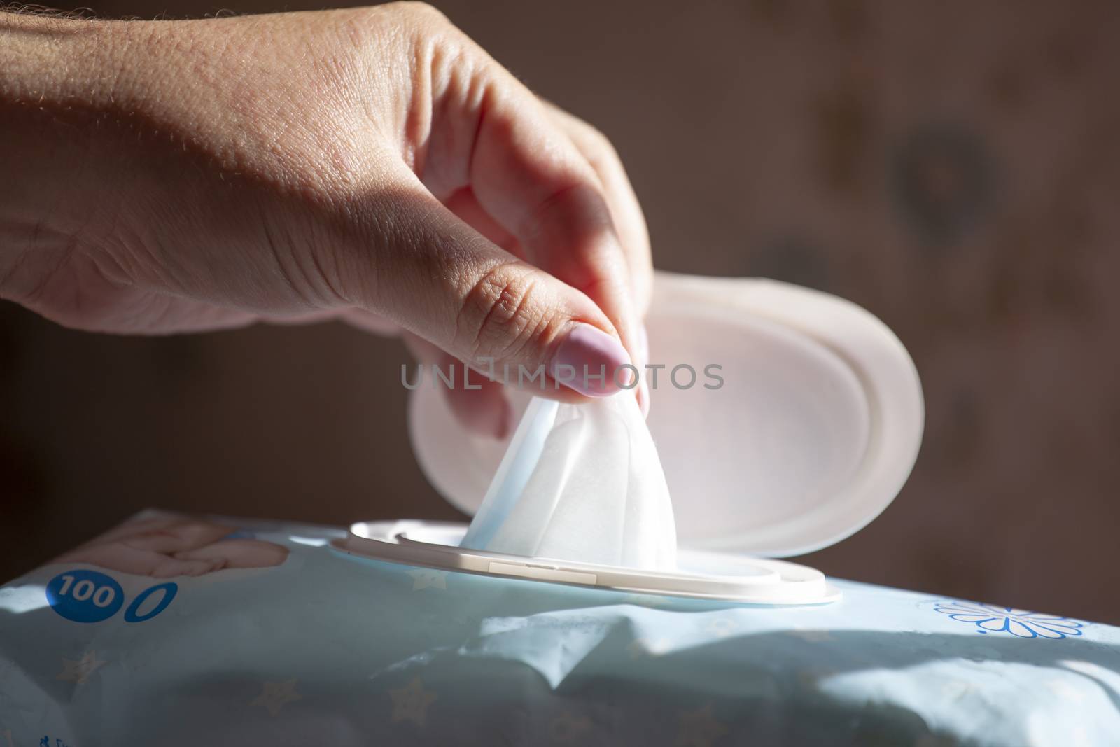 Hand picked a wet wipes in package box, Wet wipes in a woman's hand