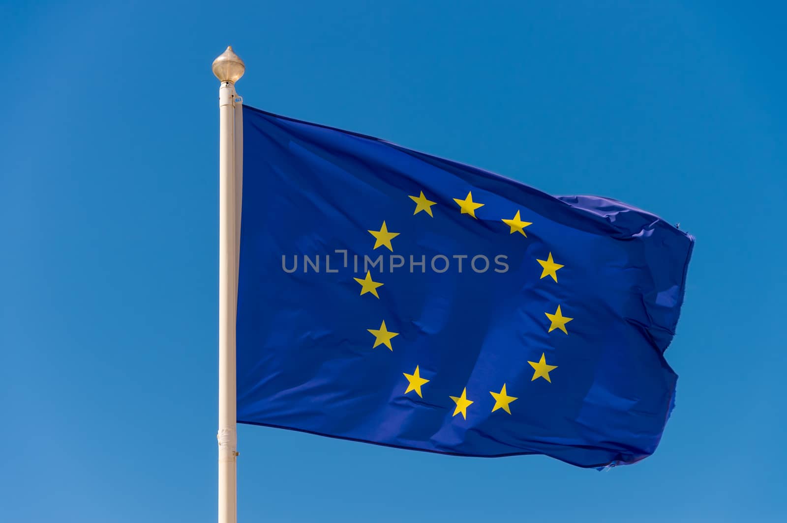 European flag waving against blue sky in Wimereux, France. by mbruxelle