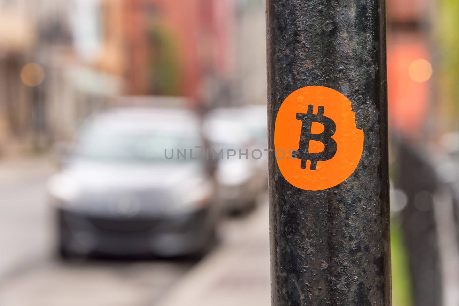 Bitcoin sticker on a street sign post by mbruxelle